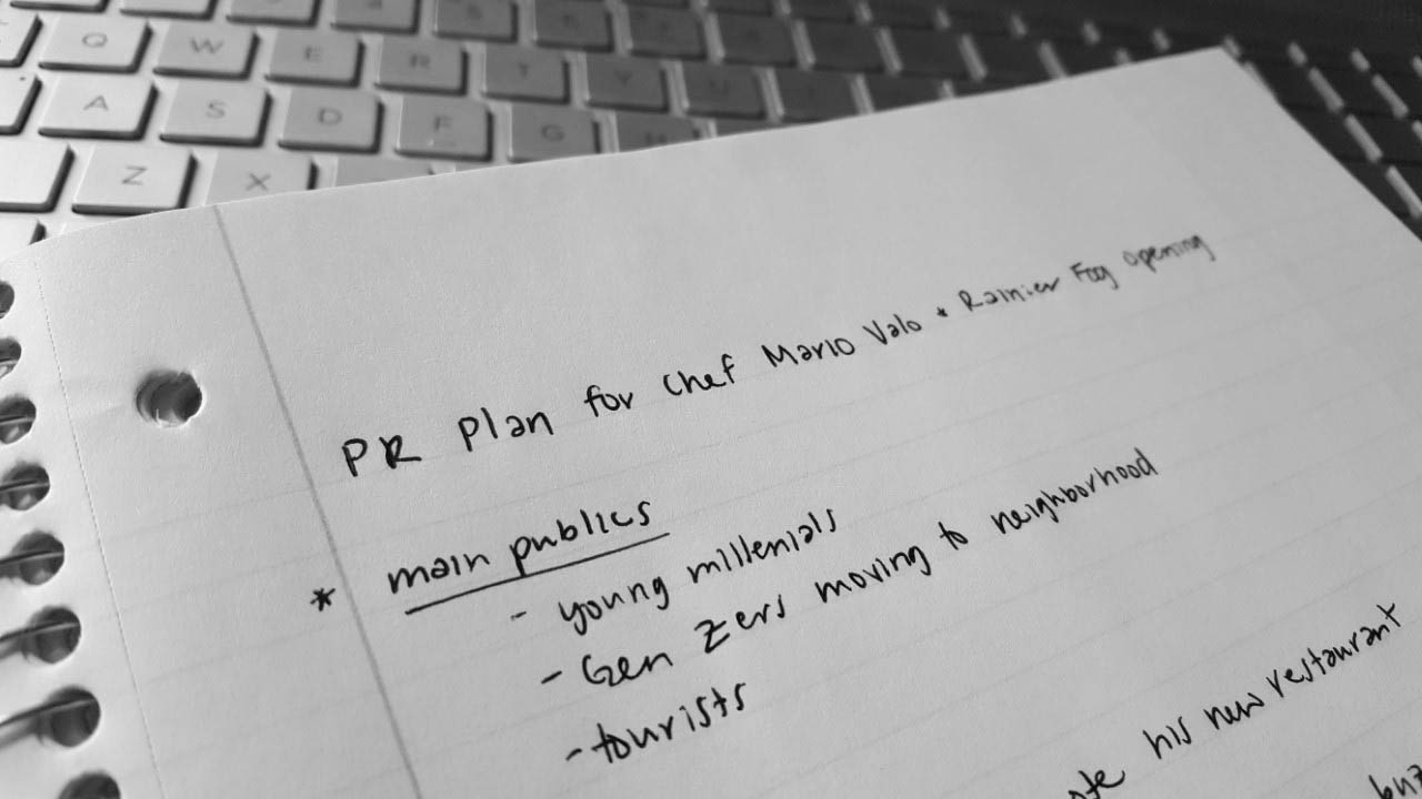black and white picture of a notebook with the words 'PR Plan for Chef Mario Valo' and notes written on it